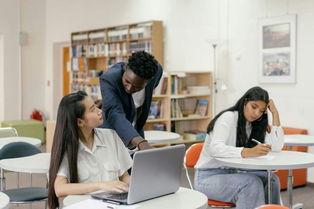 a teacher guiding his student in class