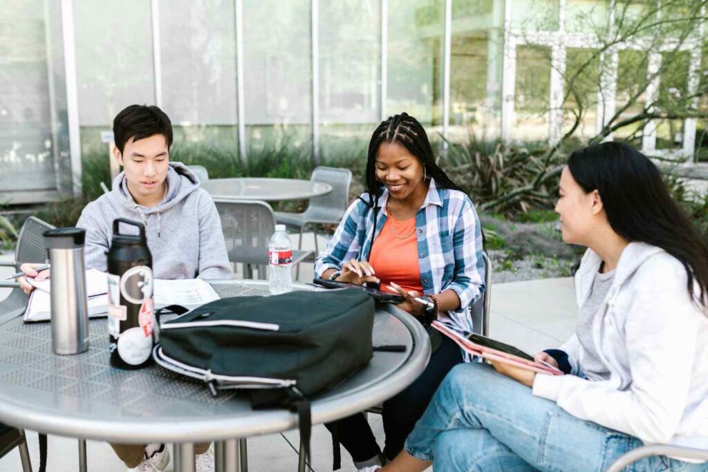Students studying together at a table on campus