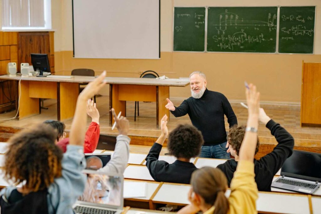Professor engaging with students in a university classroom