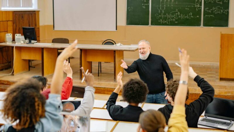 Professor engaging with students in a university classroom