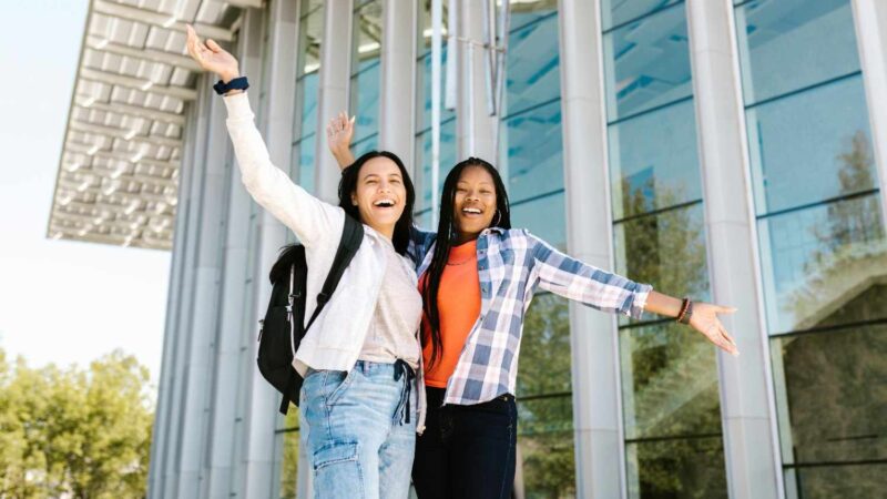 College Students Posing with Their Hands Raised
