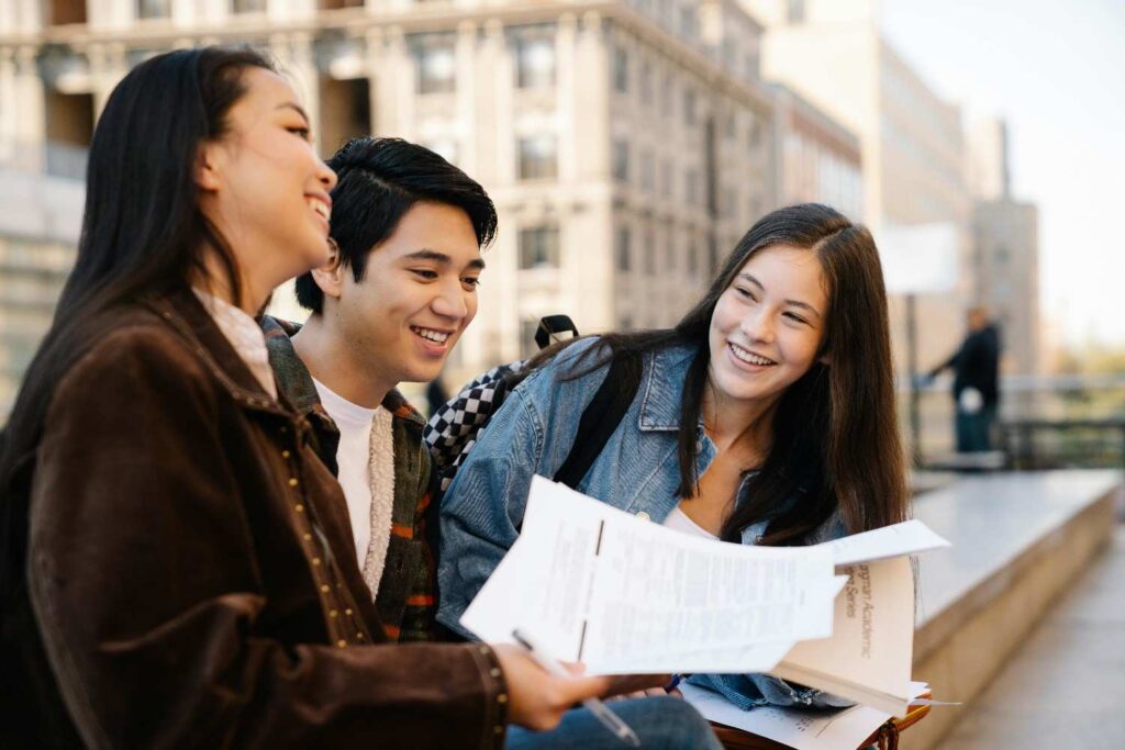 Group of Students Sitting on a Concrete Bench