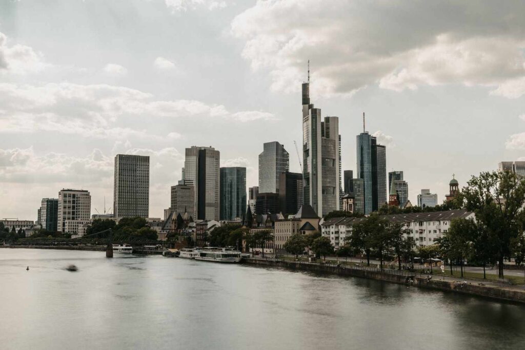 A scenic view of skyscrapers along a river during the day